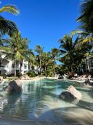 White haven surrounded by tropical gardens, pools