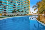 Luxury ocean-view condo with resort pool, private balcony, and washerdryer