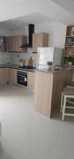 A one-bedroom apartment with a living room, kitchen, and balcony