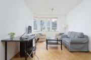 Spacious Apartment with a Balcony and Workspace Close to Downtown by Noclegi Renters