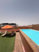 Elegant 1BR Apartment with Terrace & Rooftop Pool
