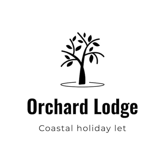 Orchard Lodge -Coastal Retreat, new build, village views, private garden and terrace