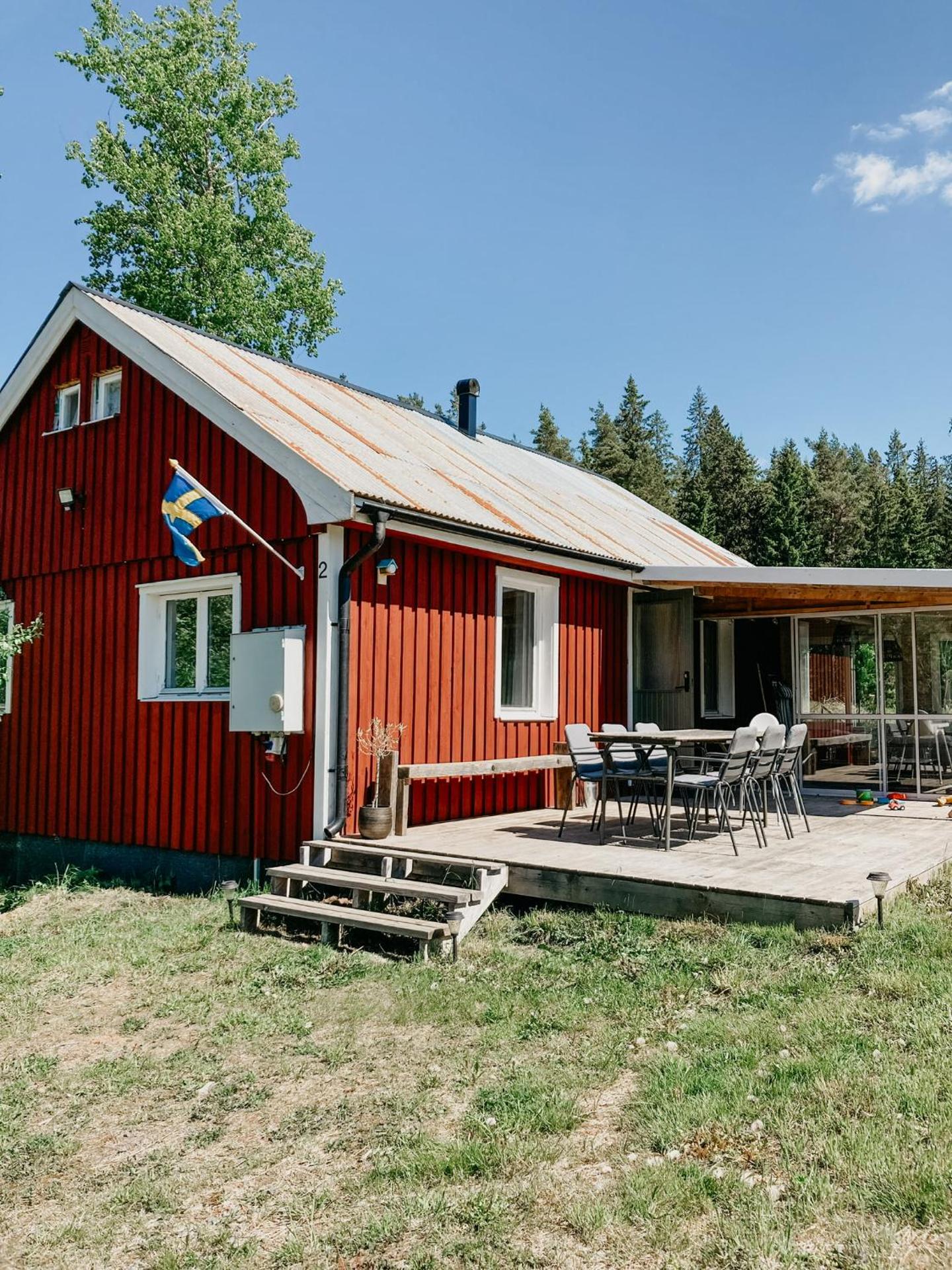 Luxurious red cottage with wood stove near lake