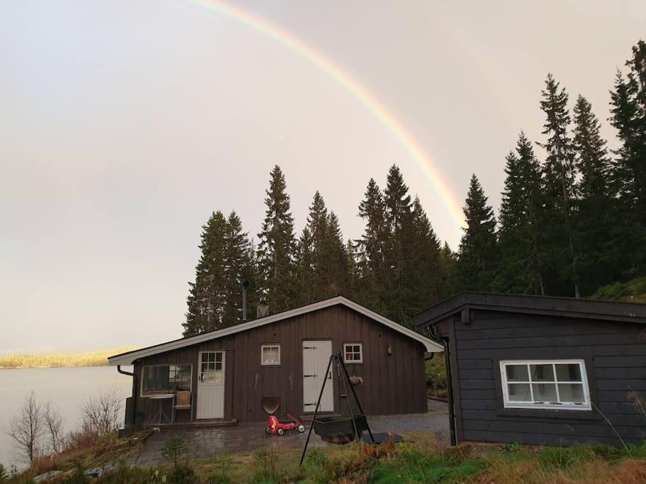 Idyllic lakeside cabin with private beach and boat
