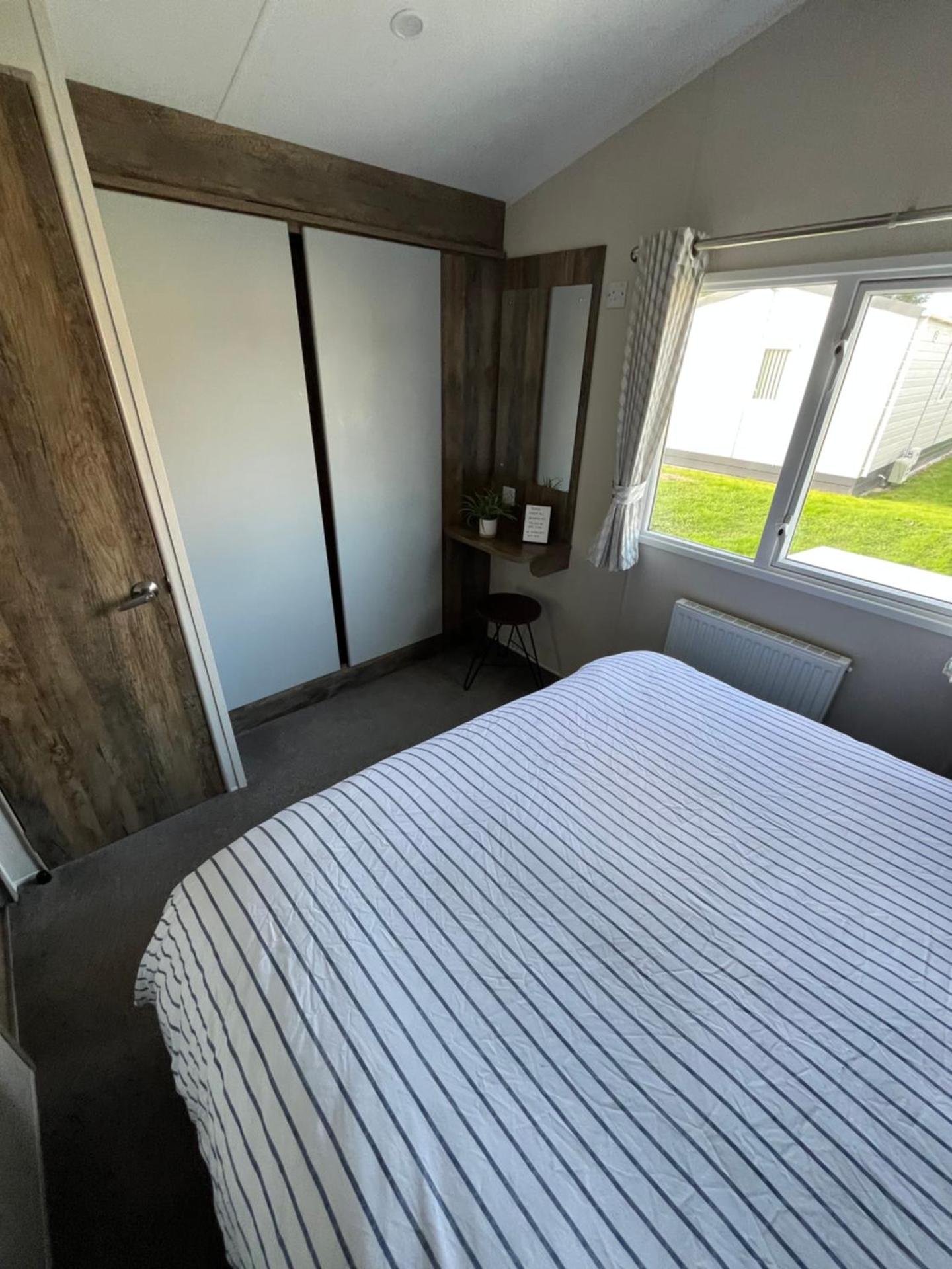 Luxury mini lodge with hot tub and decking at Tattershall Lakes