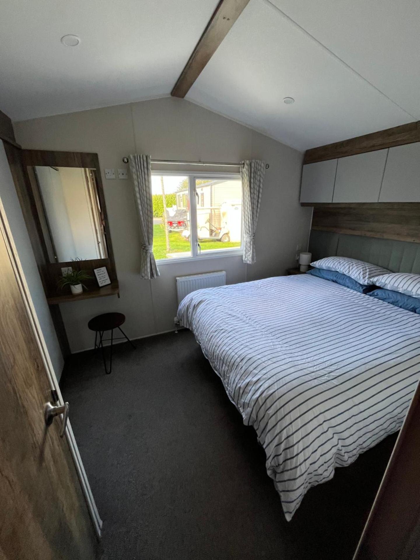 Luxury mini lodge with hot tub and decking at Tattershall Lakes