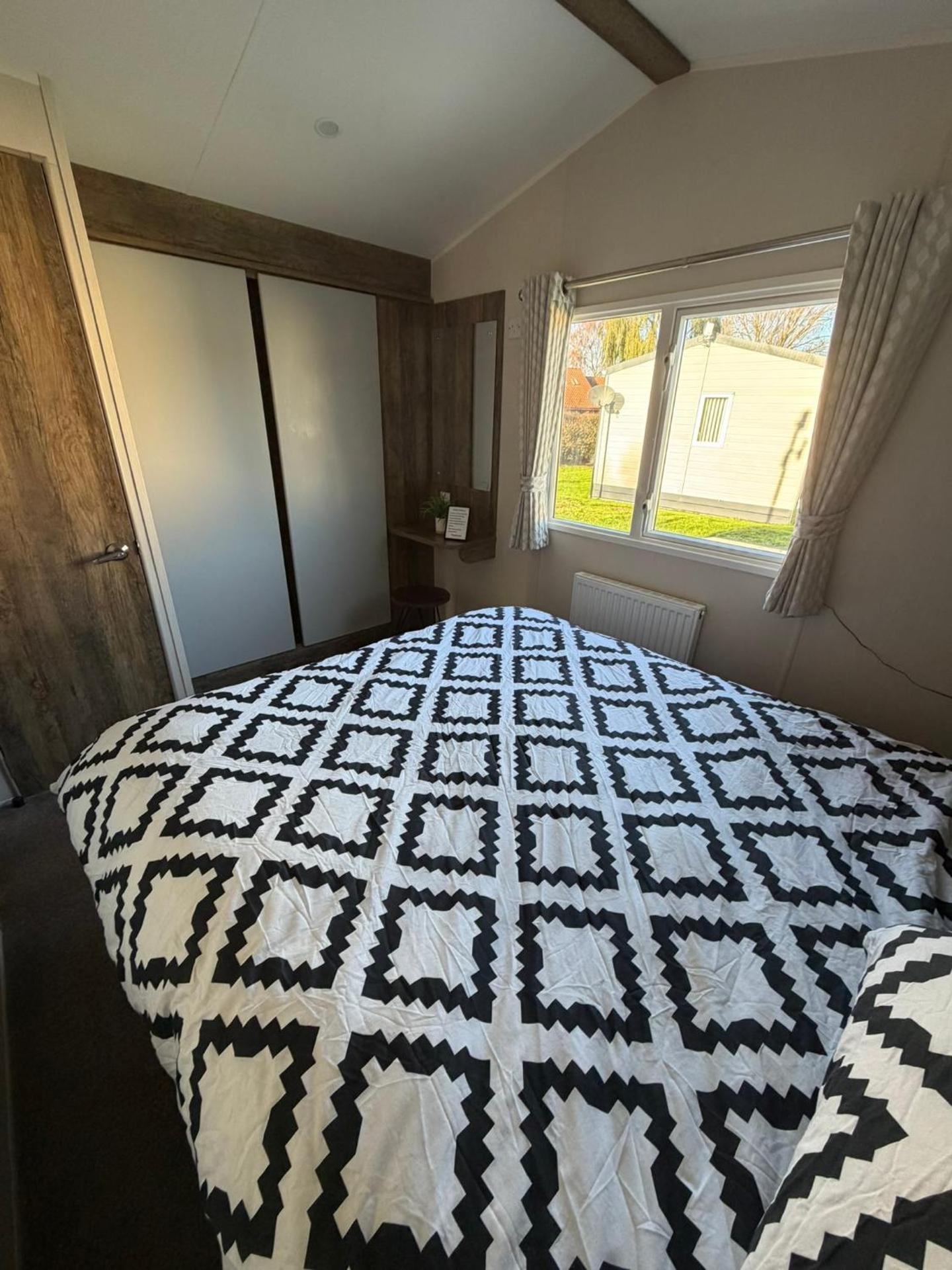 Luxury mini lodge with hot tub and decking at Tattershall Lakes