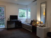 Tweepersoonskamer met 2 aparte bedden en Uitzicht op de Tuin