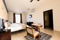 Junior Suite 1 king size bed and 1 double bed, living room, pool and garden view