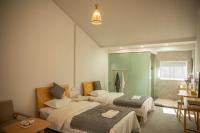 Tweepersoonskamer met 2 aparte bedden en Uitzicht op de Tuin