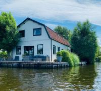 Holiday home at the water, fire place, boat and SUP rent, near Amsterdam - Ferienwohnung Aalsmeer