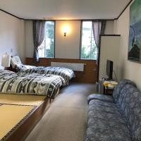 Standaardkamer met 2 eenpersoonsbedden en een bank