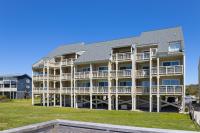 Updated third-floor condo with WiFi, shared pool, balcony, W/D, & central AC - B&B Oak Island