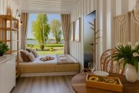 Cottage with bed by the window and lake view