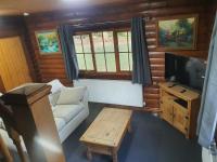 large log cabin overlooking a fishing lake - Bed and Breakfast North Somercotes