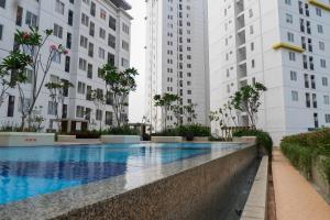 2BR Bassura City Apartment with City View By Travelio