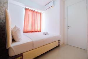 Cozy 2BR Bassura City Apartment with City View By Travelio