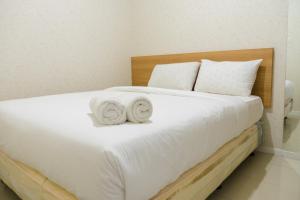 Minimalist 2BR Apartment at Parahyangan Residence By Travelio