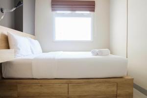 Modern and Bright 2BR Green Pramuka Apartment By Travelio