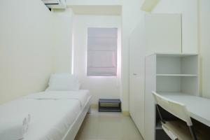 Tranquil 2BR @ Green Pramuka Apartment By Travelio