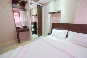Homey and Relaxing 2BR Green Pramuka City Apartment By Travelio