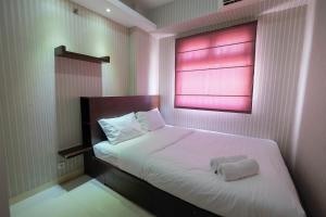 Homey and Relaxing 2BR Green Pramuka City Apartment By Travelio