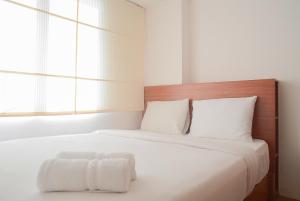 Pool View 2BR with Sofa Bed Bassura City Apartment By Travelio