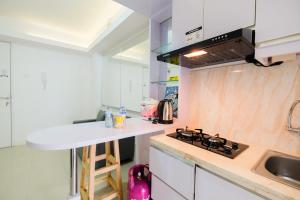 Simply Living 2BR at Bassura City Apartment By Travelio