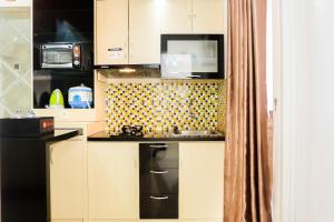 Simply 2BR with Pool View Bassura City Apartment By Travelio
