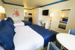 Queen Room with Two Queen Beds - Pool View room in SureStay Plus by Best Western Orlando International Drive