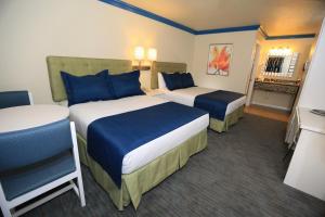 Queen Room with Two Queen Beds room in SureStay Plus by Best Western Orlando International Drive