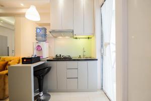 Cozy and Elegant 2BR Bassura City Apartment By Travelio