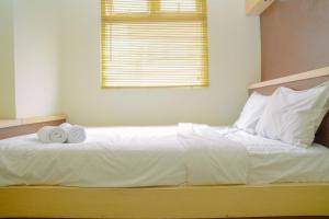 Fully Furnished and Cozy 2BR at Green Pramuka City Apartment By Travelio