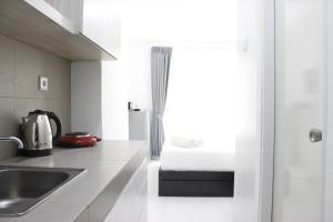 Monochrome Style Studio Room @Grand Asia Afrika Apartment By Travelio
