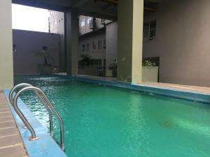 Monochrome Style Studio Room @Grand Asia Afrika Apartment By Travelio