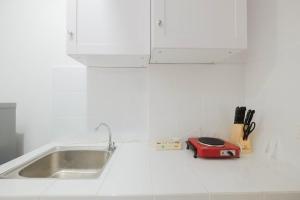 Minimalist Studio at Azalea Suites Cikarang Apartment By Travelio