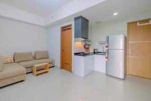 Minimalist and Posh 1BR The Oasis Cikarang Apartment By Travelio