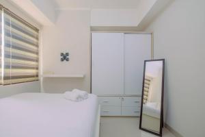 Minimalist and Posh 1BR The Oasis Cikarang Apartment By Travelio