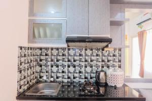 Warm and Cozy 2BR Green Pramuka Apartment near Mall By Travelio