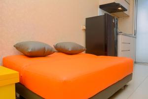 Minimalist 1BR with Pool View at Bassura City Apartment By Travelio