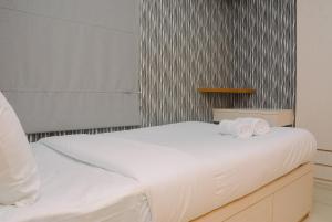 Minimalist 1BR with Pool View at Bassura City Apartment By Travelio