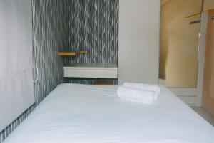 Minimalist 1BR with Pool View at Bassura City Apartment By Travelio