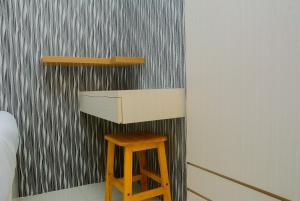 Minimalist 1BR with Pool View at Bassura City Apartment By Travelio