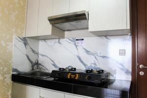 Minimalist 1BR Apartment at M-Town Signature By Travelio