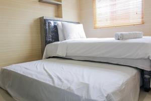 Minimalist 2BR Green Pramuka City Apartment near Shopping Mall By Travelio