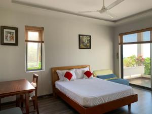 Phòng Deluxe Giường Đôi Với Ban Công và Tầm Nhìn Ra Biển (Deluxe Double Room with Balcony and Sea View)