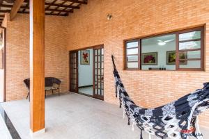 Casa na Praia Grande com piscina, churrasqueira e ar condicionado - 04 dormitórios