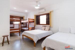 Casa na Praia Grande com piscina, churrasqueira e ar condicionado - 04 dormitórios