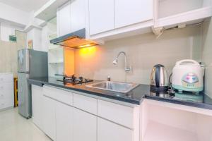 Furnished Green Pramuka 1BR Apartment with Modern Style and City View By Travelio