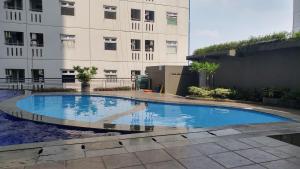Furnished Green Pramuka 1BR Apartment with Modern Style and City View By Travelio